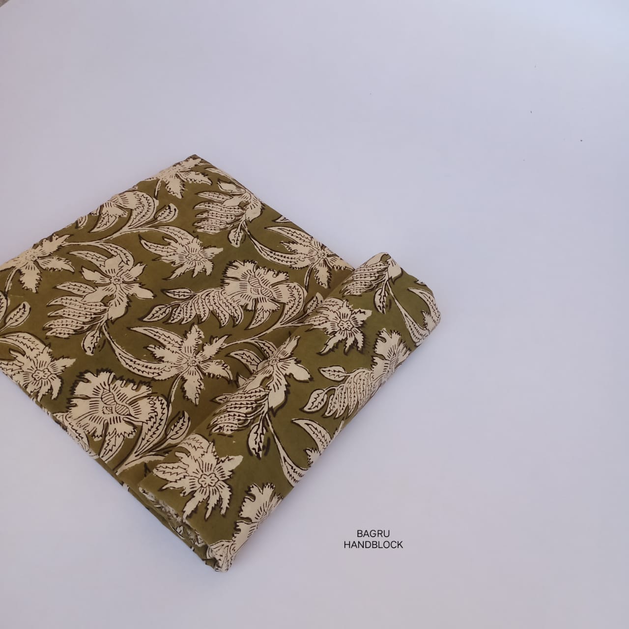 Olive-toned floral Bagru handblock printed fabric on pure cotton, slow-made and ideal for designer apparel.